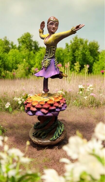 Miniature sculpture, dancer on a flower in a meadow