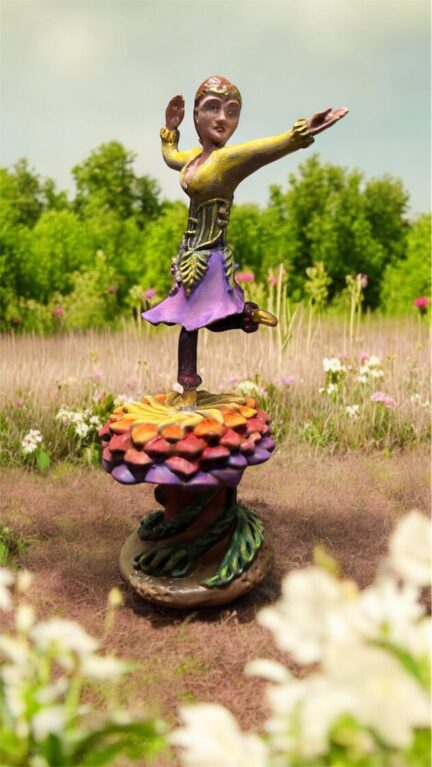 Miniature sculpture, dancer on a flower in a meadow